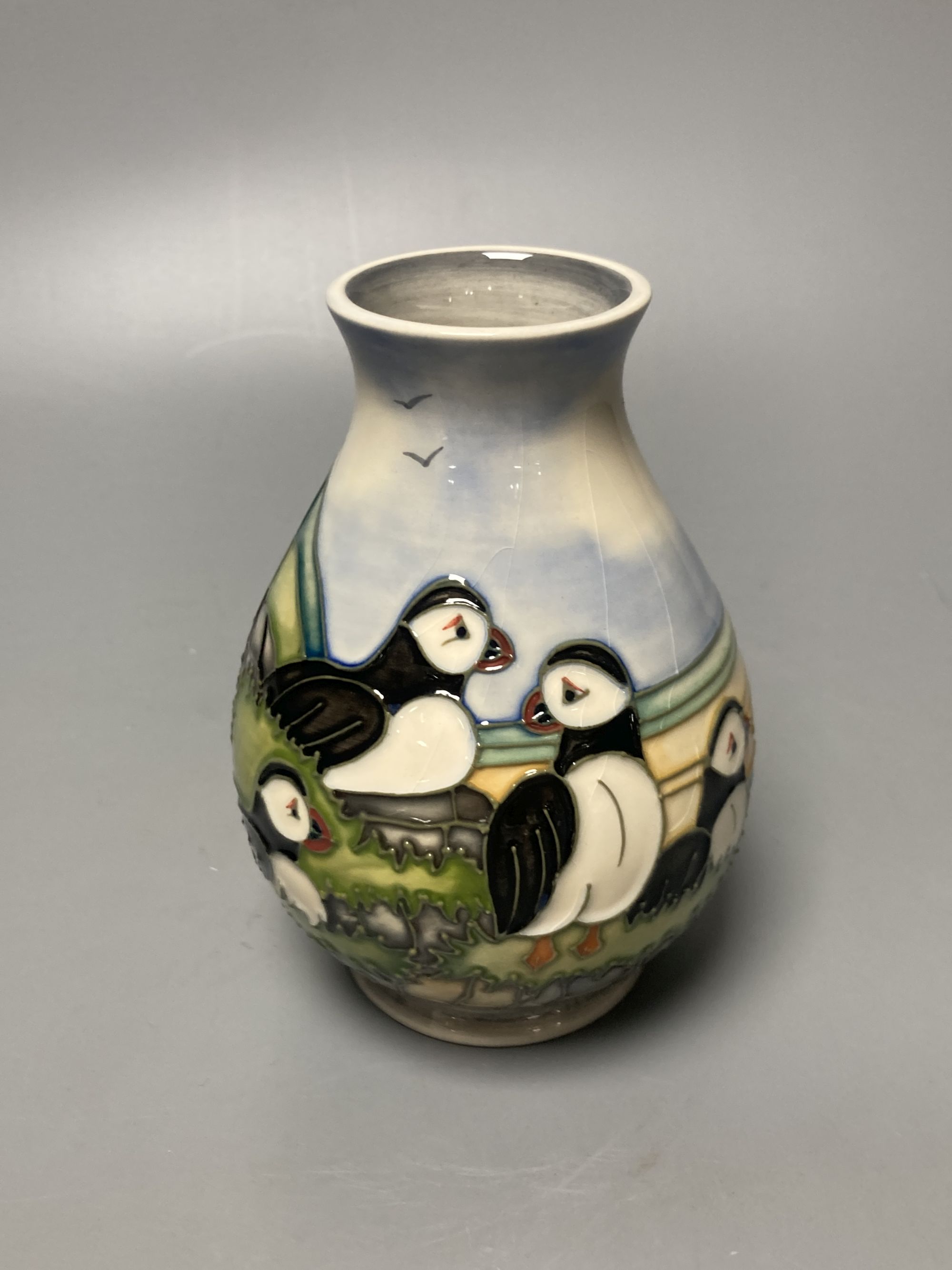 A Moorcroft puffin pattern vase, decorated by Kerri, height 14cm, boxed
